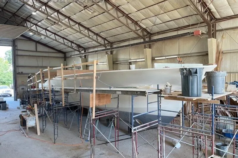 Slide: The Image of 2025 Weaver Sportfish boat under construction in a large workshop. - 4