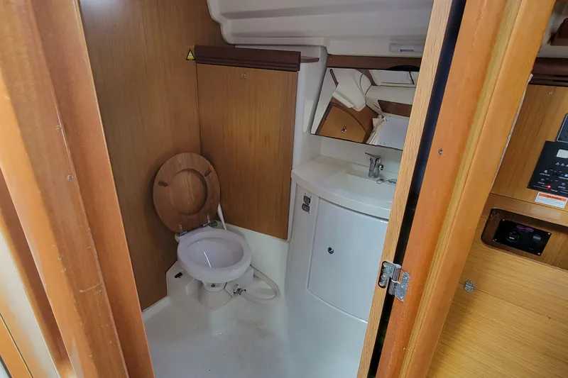Slide: The Image of 2008 Jeanneau Sun Odyssey 42 DS yacht bathroom with wooden accents and compact design. - 10