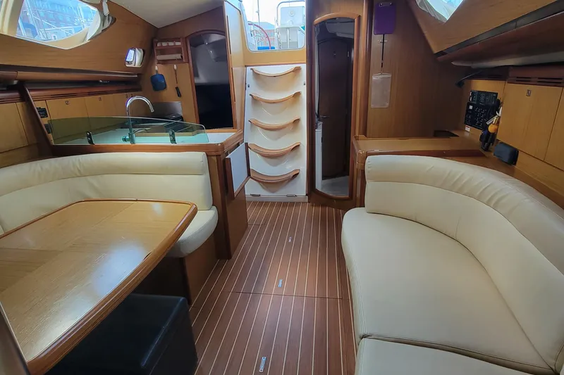 Slide: The Image of Interior of 2008 Jeanneau Sun Odyssey 42 DS sailboat with elegant wood finish and seating. - 11