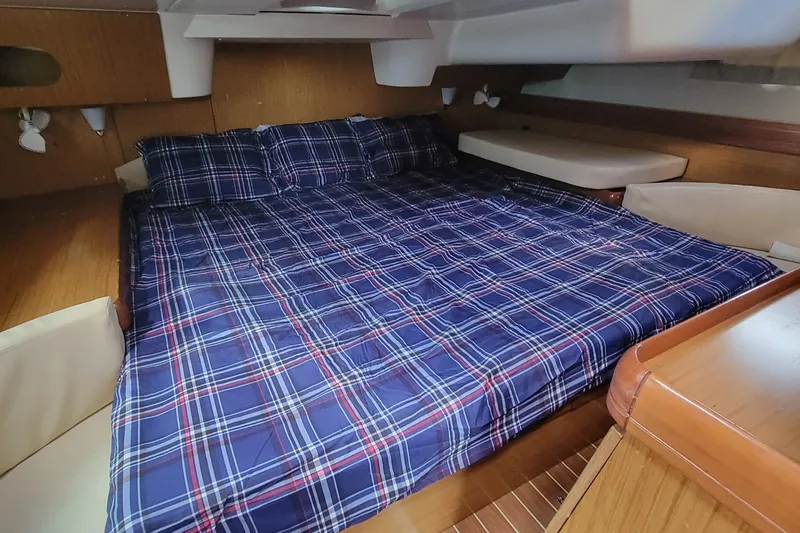 Slide: The Image of Cozy cabin interior of 2008 Jeanneau Sun Odyssey 42 DS with plaid bedding. - 13