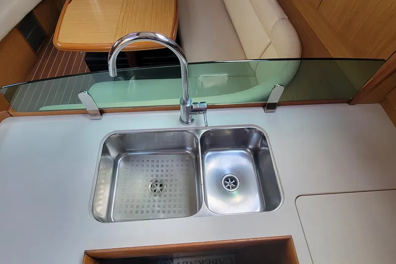 Slide: The Image of Modern kitchen sink on 2008 Jeanneau Sun Odyssey 42 DS yacht, featuring dual basins and sleek design. - 15