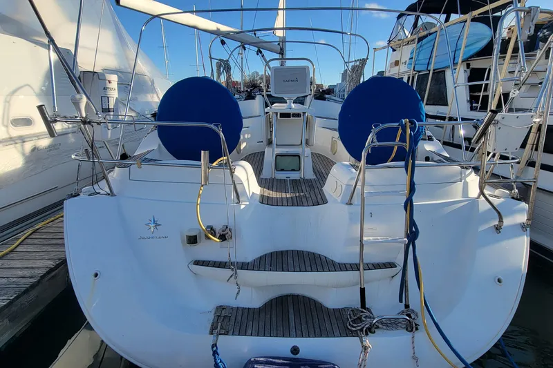 Slide: The Image of 2008 Jeanneau Sun Odyssey 42 DS sailboat docked, featuring dual steering wheels and spacious cockpit. - 17