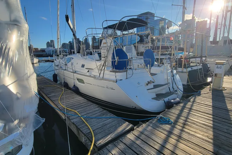 Slide: The Image of 2008 Jeanneau Sun Odyssey 42 DS sailboat docked at marina, sunny day, city skyline. - 19