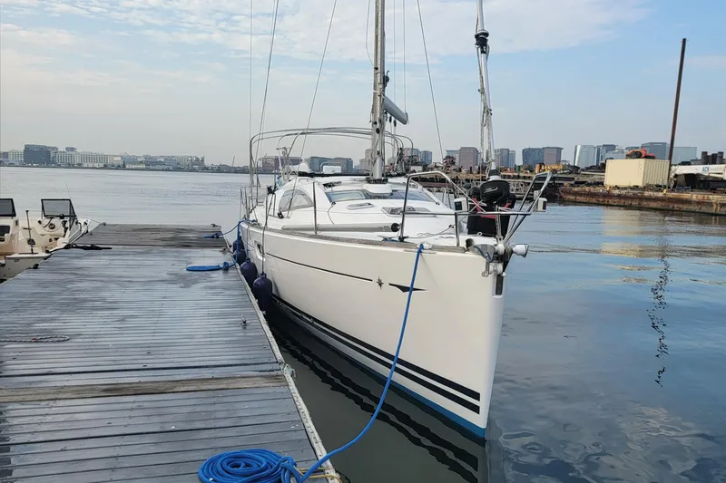 Slide: The Image of 2008 Jeanneau Sun Odyssey 42 DS sailboat docked at marina with city skyline. - 21