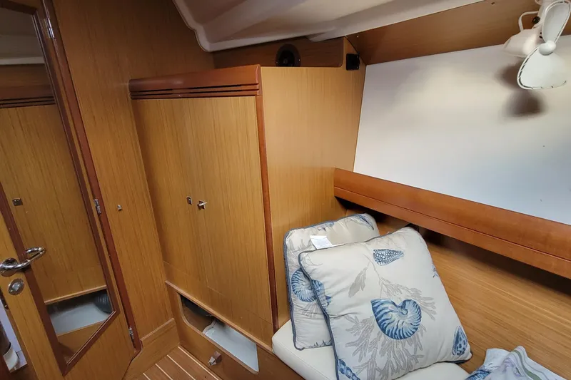 Slide: The Image of Interior cabin of 2008 Jeanneau Sun Odyssey 42 DS with wooden finish and decorative pillows. - 4