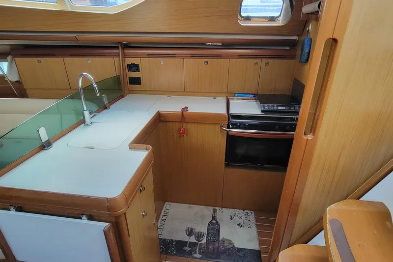 Slide: The Image of Interior of 2008 Jeanneau Sun Odyssey 42 DS yacht kitchen with modern amenities. - 7