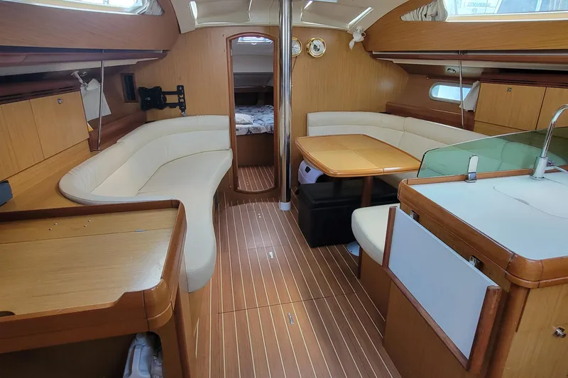 Slide: The Image of Interior of 2008 Jeanneau Sun Odyssey 42 DS yacht with elegant wood finish and seating area. - 9