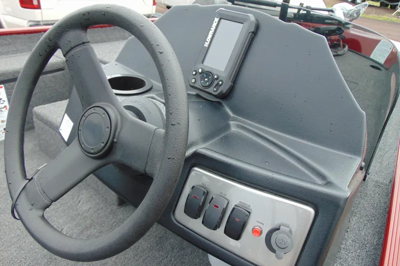 Slide: The Image of 2026 Crestliner 1700 Storm boat dashboard with steering wheel and control panel. - 4