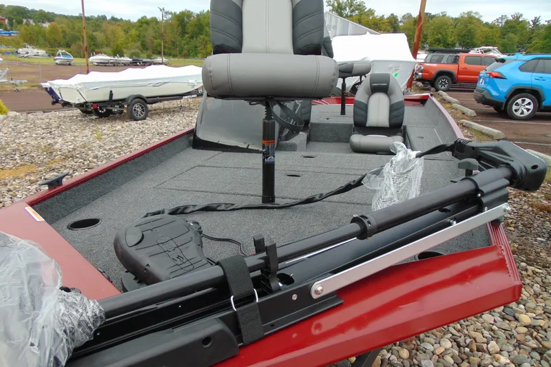 Slide: The Image of 2026 Crestliner 1700 Storm fishing boat with seating and trolling motor, parked outdoors. - 9