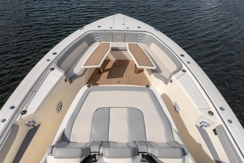 Slide: The Image of Manufacturer Provided Image: Luxurious 2025 Scout 530 LXF boat interior with seating and table on calm water. - 8