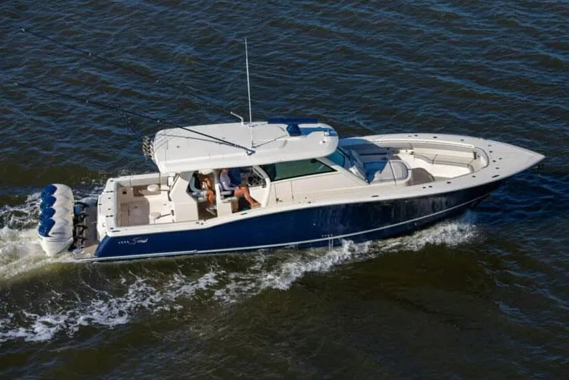 Slide: The Image of Manufacturer Provided Image: 2025 Scout 425 LXF boat cruising on open water. - 2