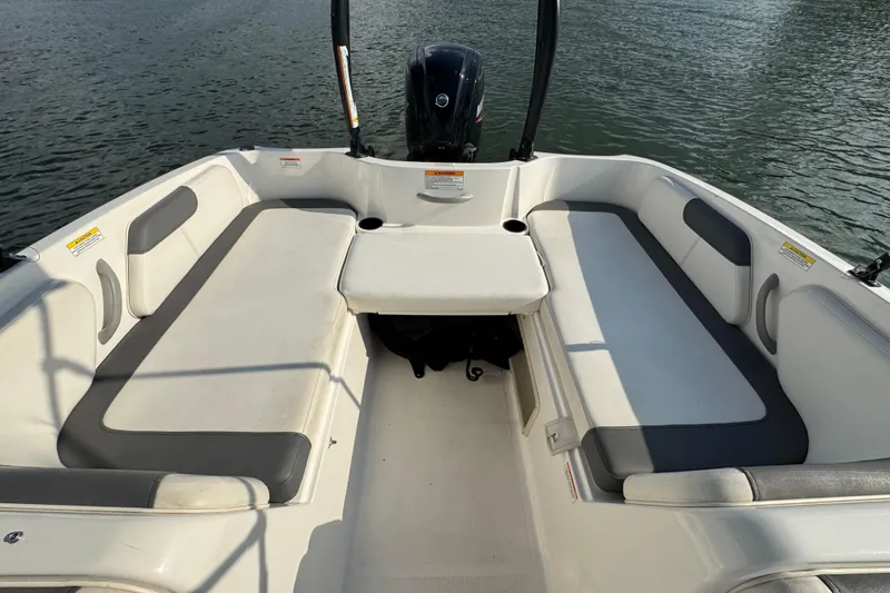 Slide: The Image of 2020 Bayliner Element E18 boat interior with seating and table on water. - 12