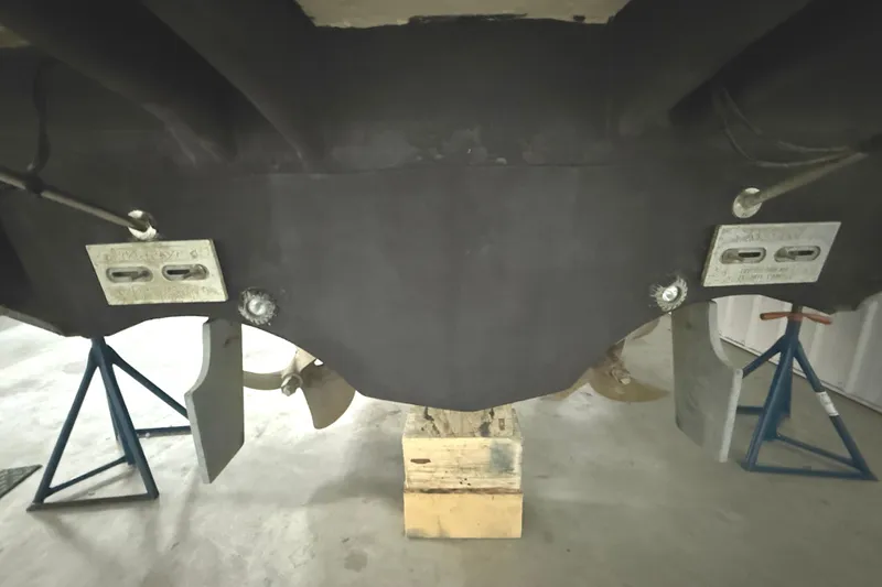 Slide: The Image of 2006 Tiara Yachts 3800 Open hull and propellers on stands in a workshop. - 10