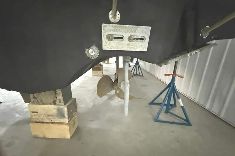 Slide: The Image of 2006 Tiara Yachts 3800 Open propeller and hull on stands in storage. - 12