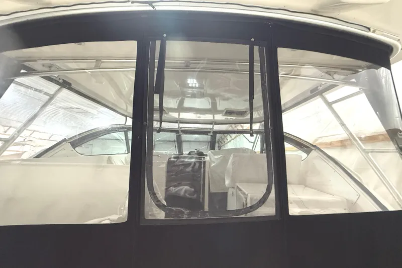 Slide: The Image of 2006 Tiara Yachts 3800 Open interior with clear enclosure and seating. - 17