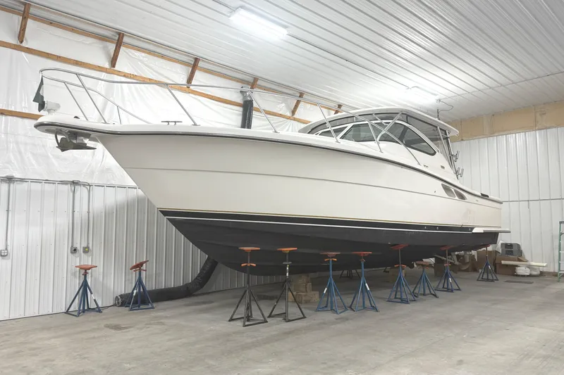 Slide: The Image of 2006 Tiara Yachts 3800 Open in storage, elevated on stands in a spacious indoor facility. - 2