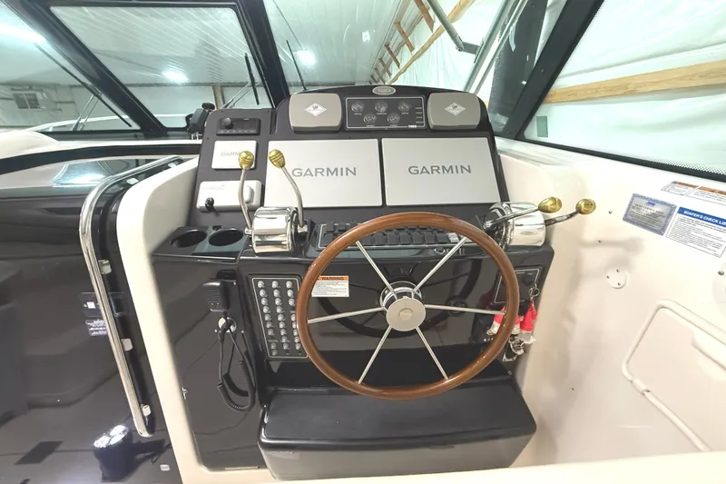 Slide: The Image of 2006 Tiara Yachts 3800 Open helm with Garmin navigation system and wooden steering wheel. - 24