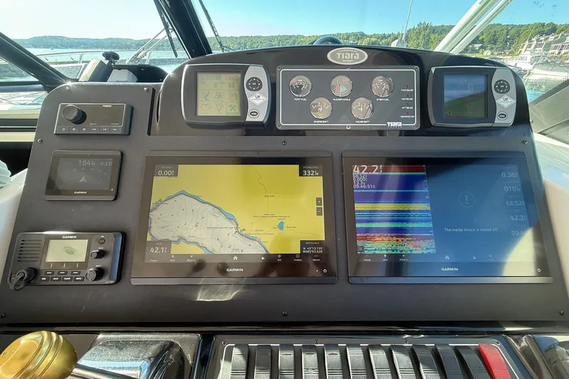 Slide: The Image of Dashboard of a 2006 Tiara Yachts 3800 Open with navigation and control systems. - 25