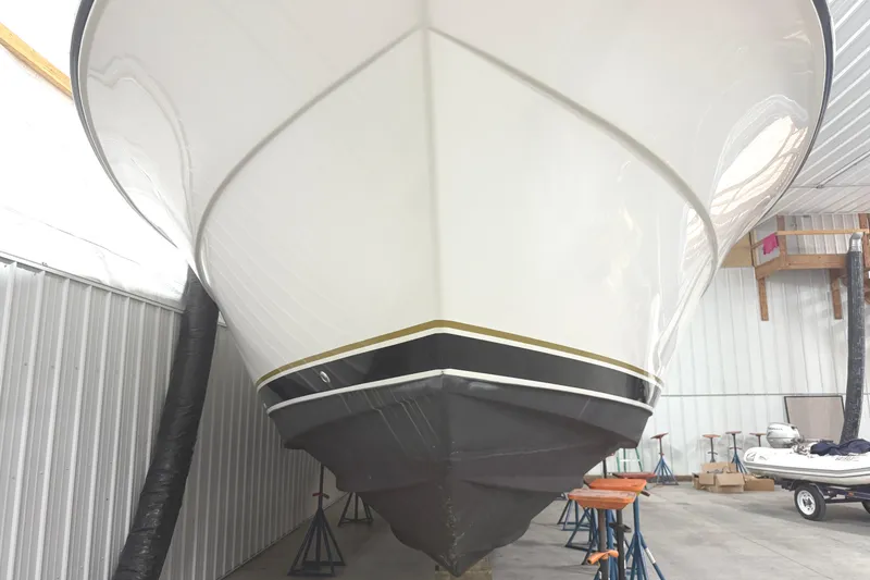 Slide: The Image of 2006 Tiara Yachts 3800 Open in storage, showcasing sleek hull design. - 3