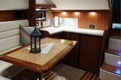 Slide: The Image of Interior of 2006 Tiara Yachts 3800 Open with elegant dining area and kitchenette. - 30