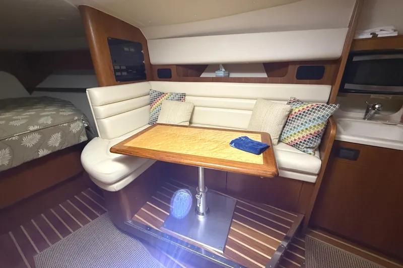 Slide: The Image of 2006 Tiara Yachts 3800 Open interior with cozy seating and wooden table. - 31