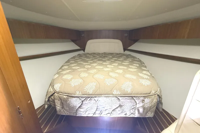 Slide: The Image of 2006 Tiara Yachts 3800 Open cabin with bed and wooden interior. - 34