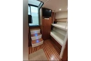 Slide: The Image of 2006 Tiara Yachts 3800 Open interior with wooden flooring and bunk beds. - 35