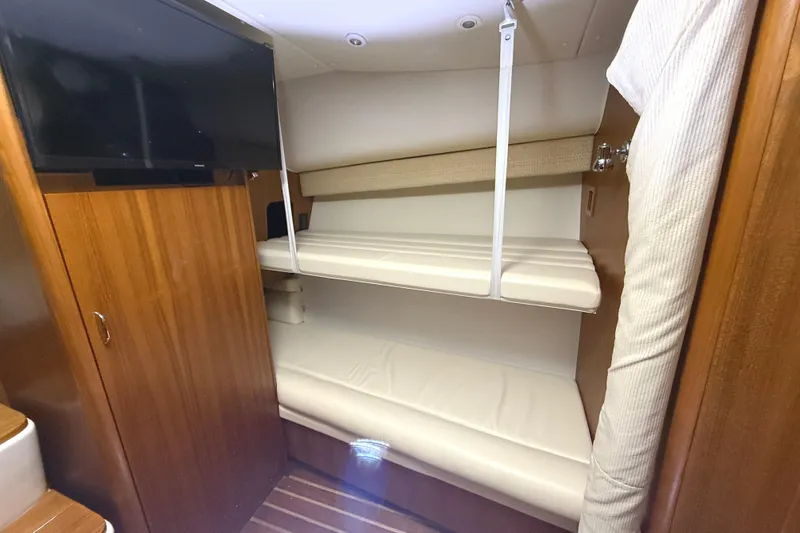 Slide: The Image of Interior of 2006 Tiara Yachts 3800 Open with bunk beds and wooden cabinetry. - 36
