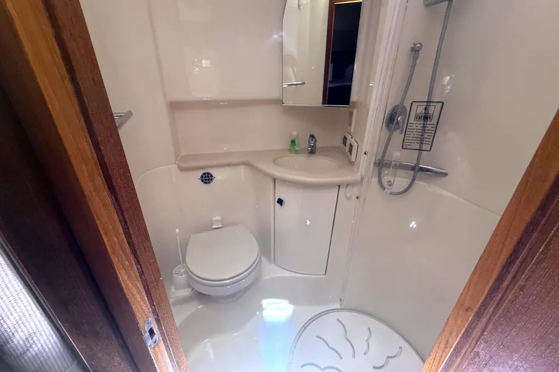 Slide: The Image of Bathroom interior of 2006 Tiara Yachts 3800 Open, featuring shower, toilet, and sink. - 38