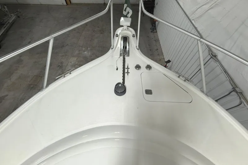 Slide: The Image of Bow of 2006 Tiara Yachts 3800 Open, featuring anchor and railing in a storage setting. - 5