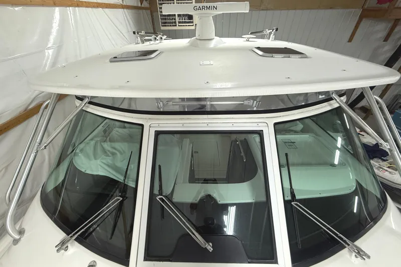 Slide: The Image of 2006 Tiara Yachts 3800 Open boat with Garmin radar, docked indoors. - 7