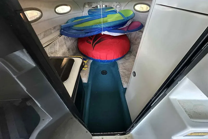 Slide: The Image of Interior of 1995 Genesis Boats 2505 with inflatables and compact cabin space. - 18