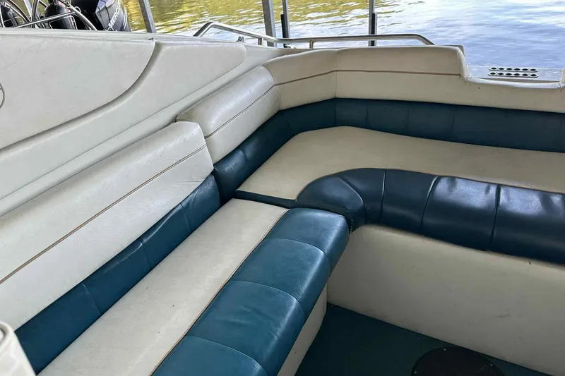 Slide: The Image of Interior seating of 1995 Genesis Boats 2505, featuring blue and white upholstery. - 5