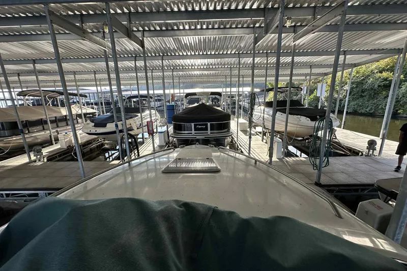 Slide: The Image of Covered marina with various boats, including a 1995 Genesis Boats 2505, docked in slips. - 10