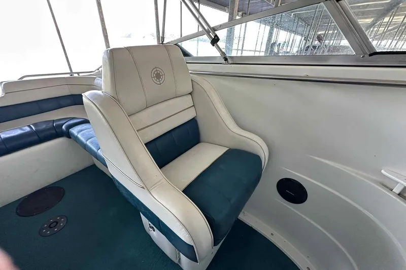 Slide: The Image of Interior of a 1995 Genesis Boats 2505, featuring blue and white seating. - 12