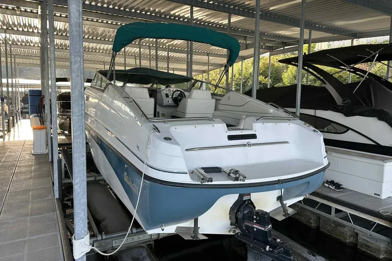 Slide: The Image of Genesis Boats 2505, 1995 model, docked in a covered marina. - 15