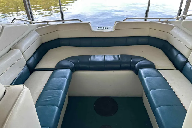 Slide: The Image of Interior seating of a 1995 Genesis Boats 2505, featuring blue and white upholstery. - 2