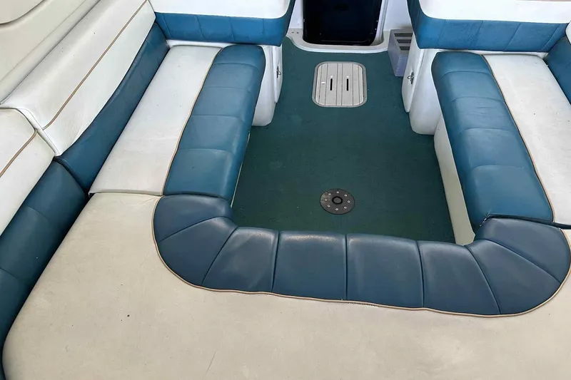Slide: The Image of Interior seating of a 1995 Genesis Boats 2505, featuring blue and white upholstery. - 20