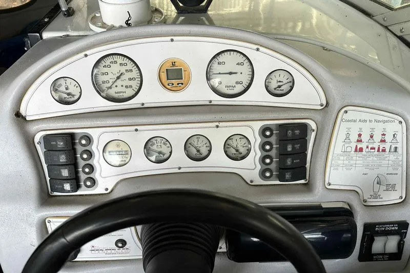Slide: The Image of 1995 Genesis Boats 2505 dashboard with gauges and navigation aids. - 22