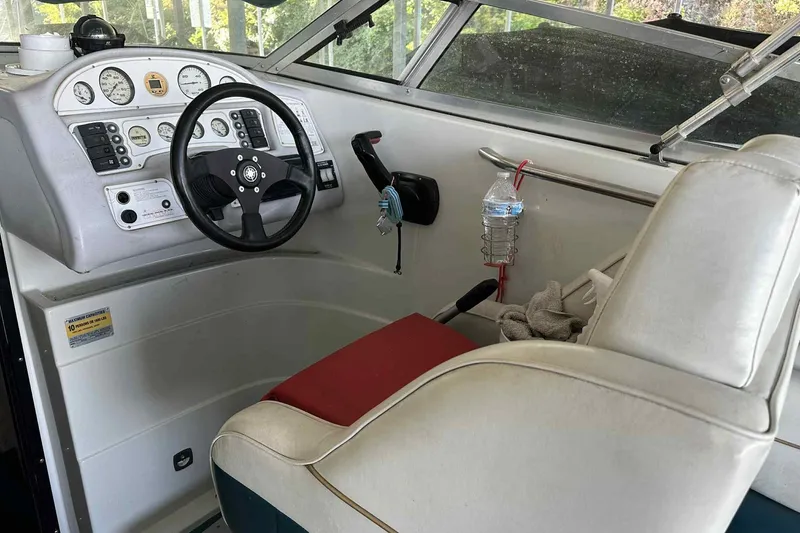Slide: The Image of Interior of a 1995 Genesis Boats 2505, featuring steering wheel and control panel. - 3