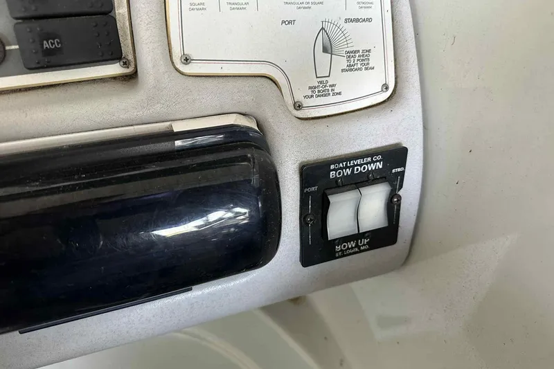 Slide: The Image of Control panel of a 1995 Genesis Boats 2505 with boat leveler switches. - 9