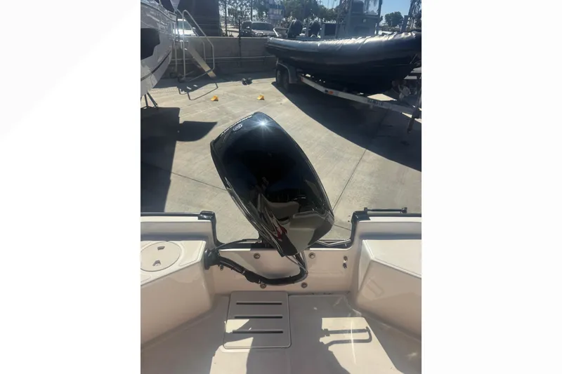 Slide: The Image of 2023 Boston Whaler 150 Montauk boat engine in a sunny outdoor setting. - 13