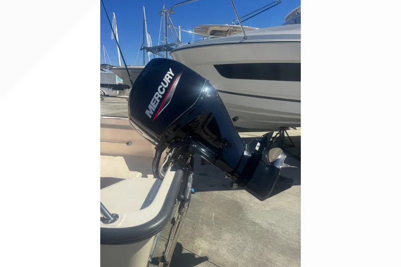 Slide: The Image of 2023 Boston Whaler 150 Montauk with Mercury outboard motor, docked in marina. - 14