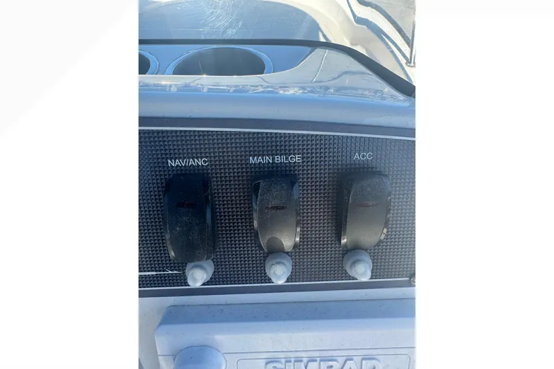 Slide: The Image of Control panel of a 2023 Boston Whaler 150 Montauk boat with switches. - 17