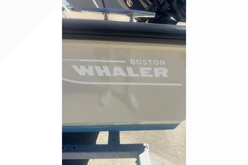 Slide: The Image of 2023 Boston Whaler 150 Montauk boat logo on hull, close-up view. - 21