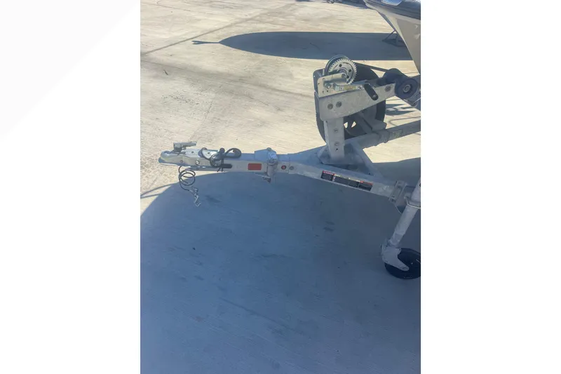 Slide: The Image of Trailer hitch of a 2023 Boston Whaler 150 Montauk boat on concrete surface. - 23