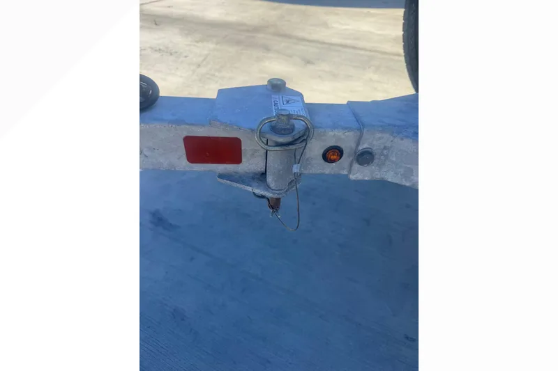 Slide: The Image of Trailer hitch of a 2023 Boston Whaler 150 Montauk on concrete surface. - 24