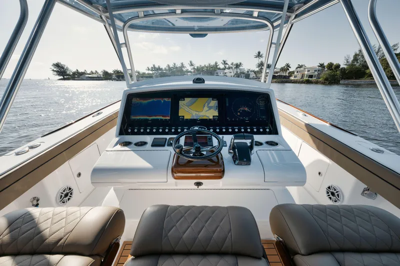 Slide: The Image of 2023 Valhalla Boatworks V-41 helm with advanced navigation system on calm waters. - 12
