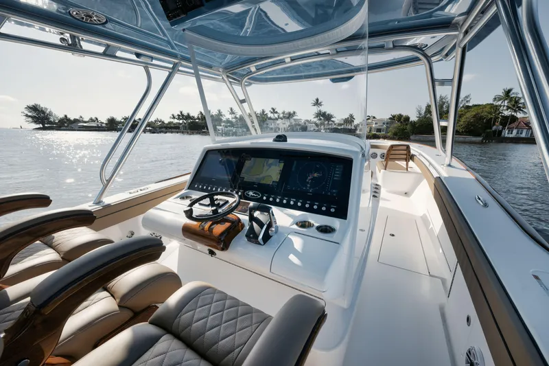 Slide: The Image of 2023 Valhalla Boatworks V-41 helm with advanced navigation system, cruising on a sunny day. - 13