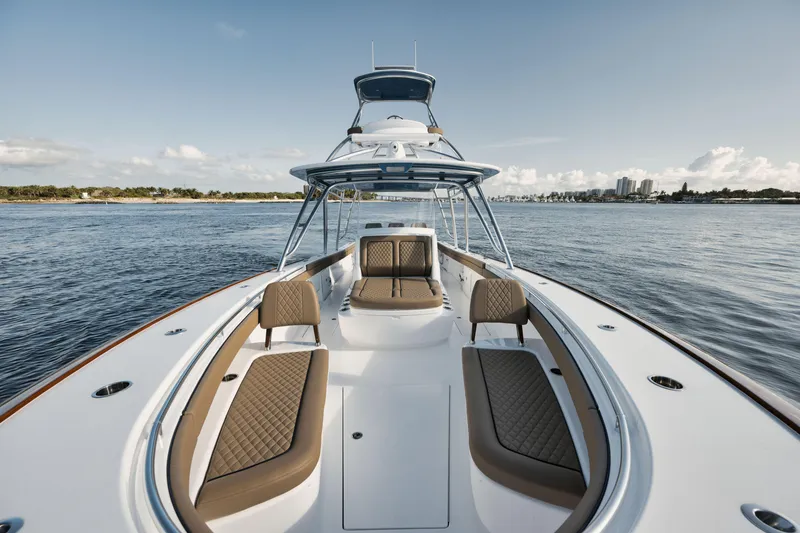 Slide: The Image of 2023 Valhalla Boatworks V-41 luxury boat on calm water, featuring elegant seating and sleek design. - 18